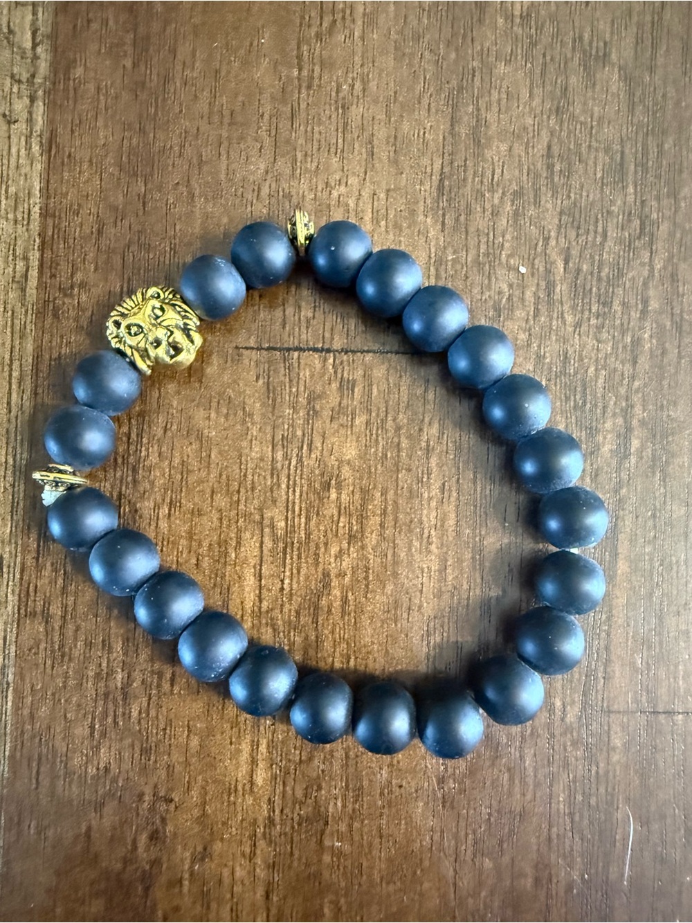 Matte Black Beaded Bracelet with Gold Lion Accent